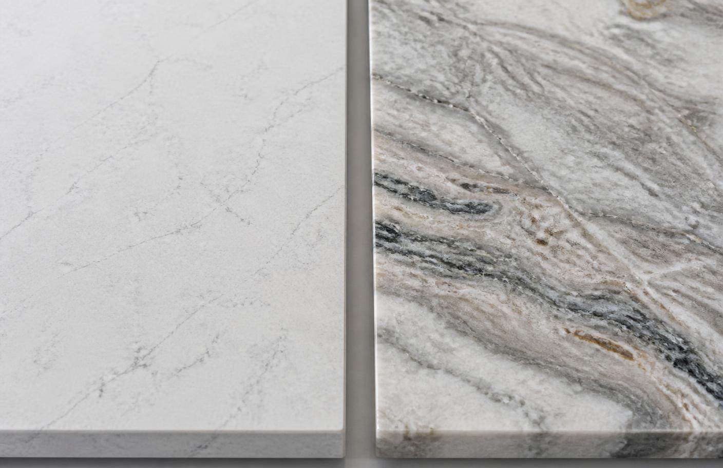 Engineered quartz slab with consistent veining beside a natural quartzite slab with unique dramatic movement
